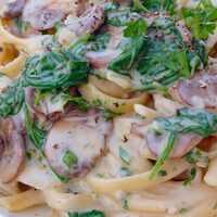 Serveersuggestie Romige fettuccine met champignons en spinazie